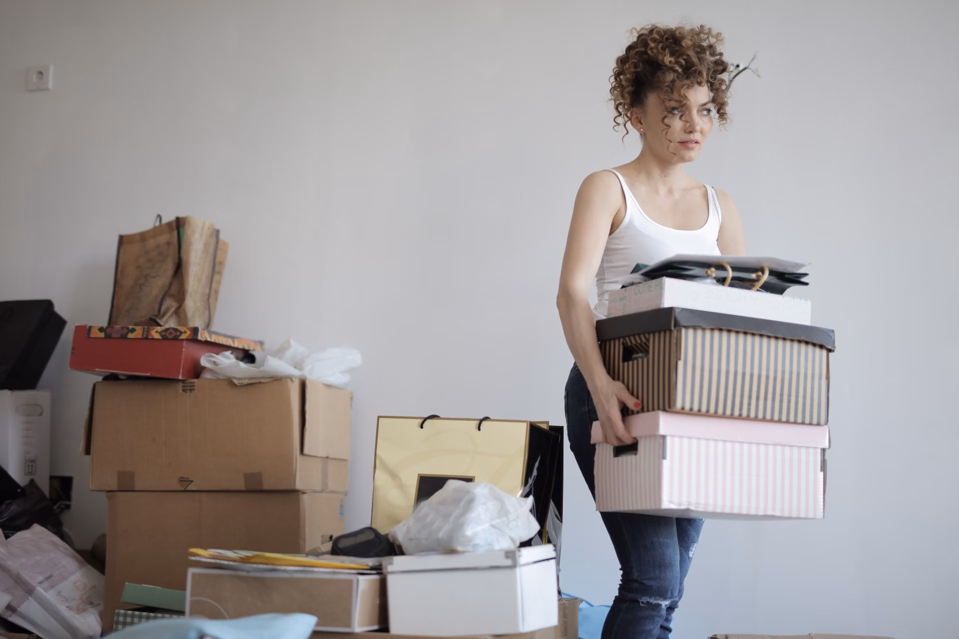 Homeowner carrying labeled boxes during a cleanout